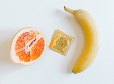 Condom Between Orange and Banana