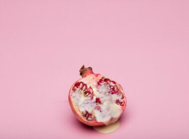 red and white fruit on pink surface