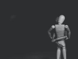 grayscale photo of joint action figure hugging one another