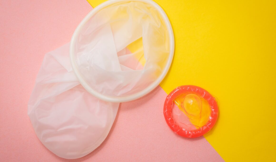 red condom on pink and yellow surface